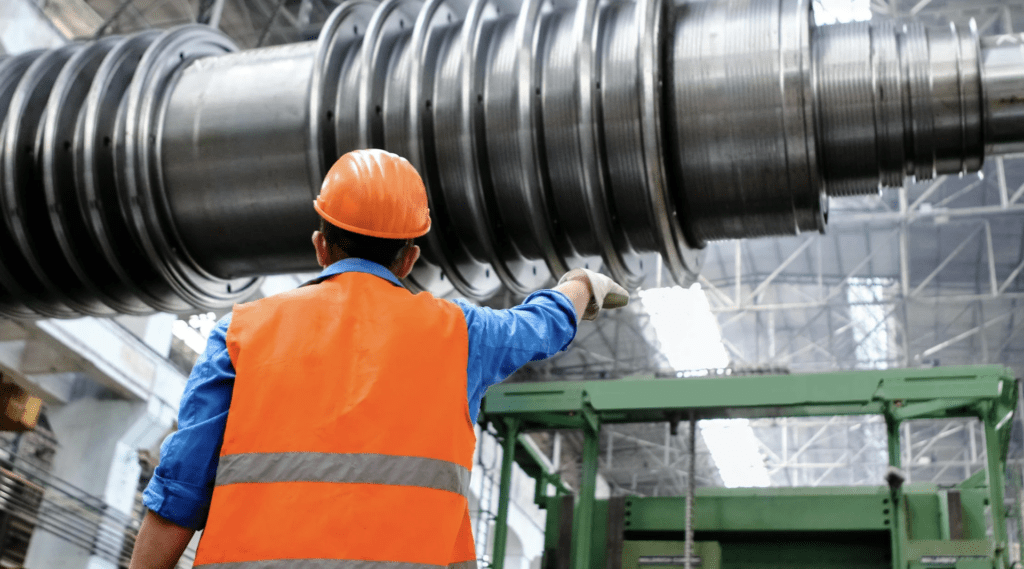 Man directing industrial workplace loading sequence.